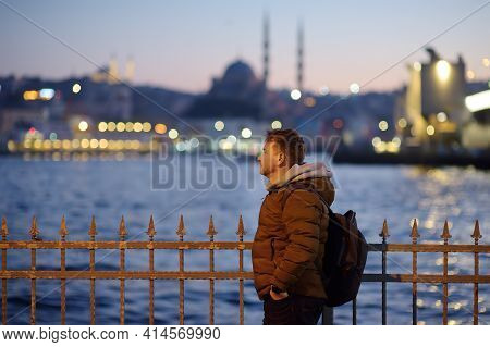 Handsome Man On A Coast Of The Golden Horn Bay In Istanbul, Turkey In The Evening. Suleymaniye Mosqu