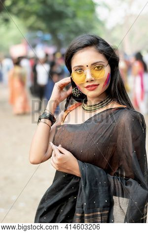 Portrait Of Beautiful Happy Young Indian Woman With Spring Festive Make Up Celebrating Holi With Pow
