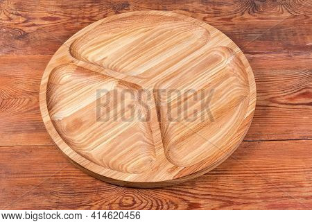 Empty Round Compartmental Dish With Three Departments Made With Natural Oak Wood On An Old Rustic Ta