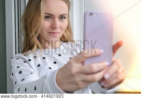Blonde Young Girl Taking Selfie. Video Call. Online Education. Work From Home. Woman Holding Smartph