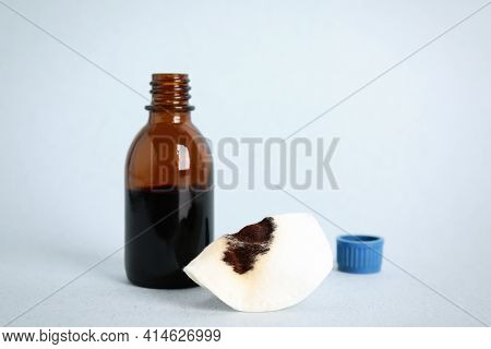 Bottle Of Medical Iodine And Cotton Pad On Light Table, Space For Text