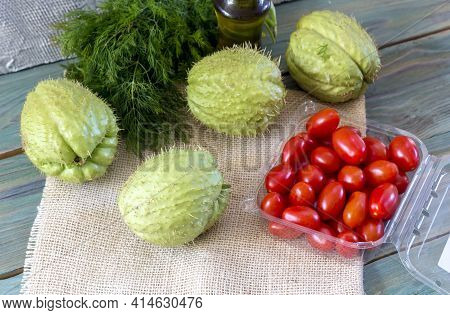 The Fruits Of Mexican, Healthy Liana (sechium Edule) Cherry Tomatoes, Dill And Olive Oil On Wooden T
