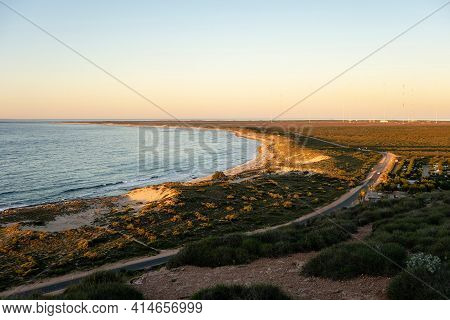 Landscape Of Coastline Near Coastline And Vlamingh Head Precinct Lighthouse At Sunset With Antenna A