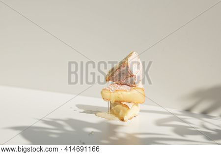 Delicious Honeycombs With Camembert On A White Board.