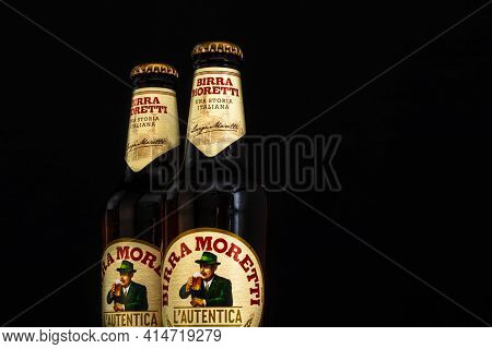 Bottle Of Birra Moretti Beer On Wooden Barrel With Dark Background. Illustrative Editorial Photo Buc