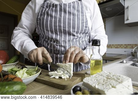 Woman Prepare Greek Salad In Your Kitchen. Home Made Cooking Greek Salad .