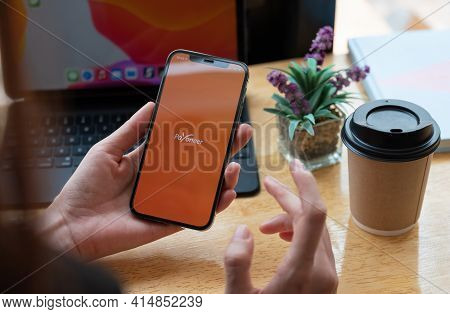 Chiang Mai, Thailand - Mar 07, 2021 : A Woman Holds Smartphone With Payoneer Mobile Phone App, Busin