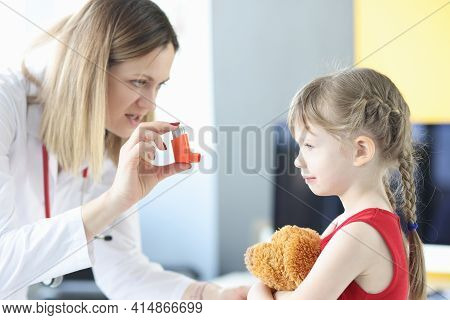 Pulmonologist Doctor Holding Hormonal Inhaler In Front Of Little Girl
