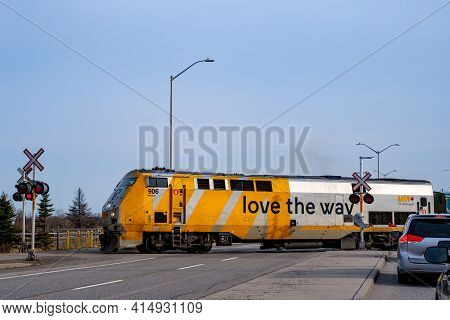 Ottawa, Ontario, Canada - March 25, 2021: A Via Rail Train Crosses Woodroofe Avenue As It Departs Fa