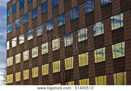 Windows Of A Business House Mirroring The Sky