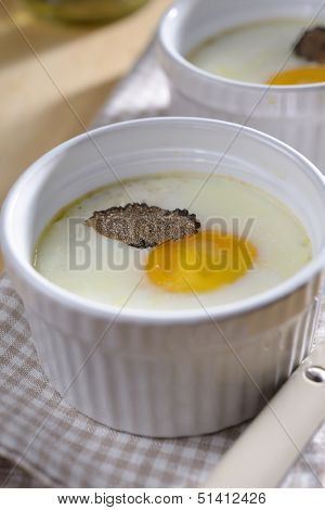 Baked egg with sliced truffle in a ramekin