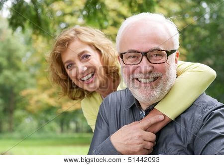 Happy Older Woman Embracing Smiling Older Man