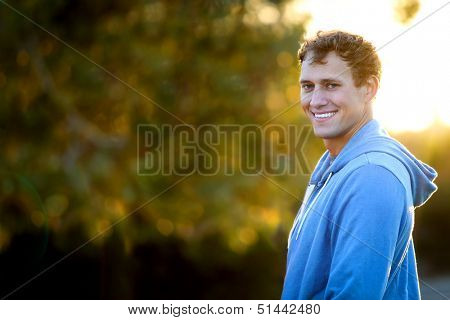Young man standing outside in the sun