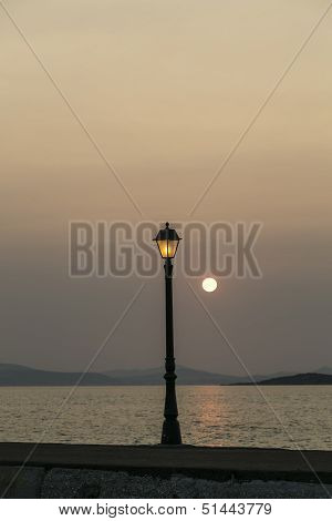 Sunset In A Habor With Old Street Light