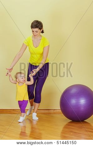Mother Do Phisical Exercises With Her Daughter At Home
