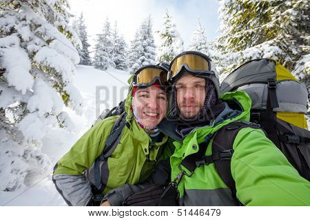 Two Funnny Hikers Posing At Camera In Winter Mountains