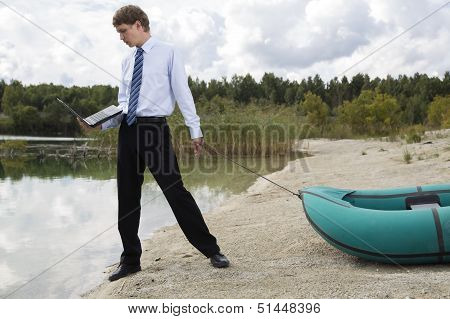 Dressed Man Plan Drags Boat At Lake