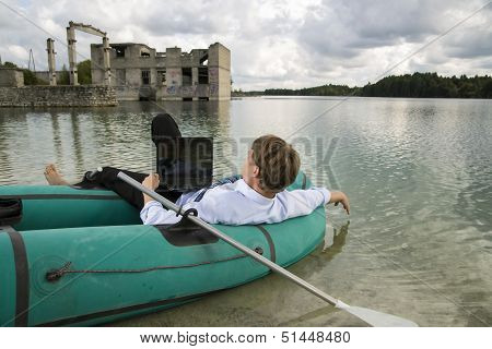 Dressed Man Lay Over Boat On Lake