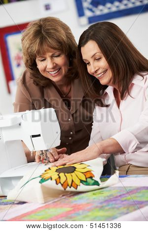 Two Women Using Electric Sewing Machine