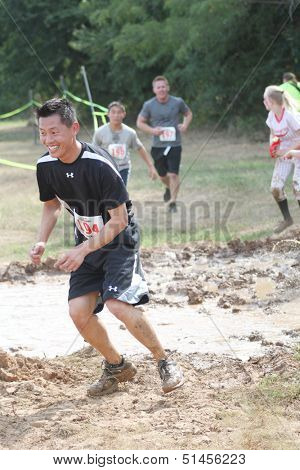 MUSKOGEE, OK - Sept. 14: Zombies attack runners and attempt to grab their red life flags  during the Castle Zombie Run at the Castle of Muskogee in Muskogee, OK on September 14,  2013.