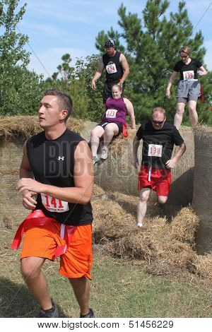 MUSKOGEE, OK - SEPT.14:  Athletes and actors portraying zombies participate in the first annual Zombie Run at the Castle of Muskogee in Muskogee, OK. on September 14, 2013.