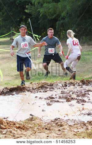 MUSKOGEE, OK - Sept. 14: Zombies attack runners and attempt to grab their red life flags  during the Castle Zombie Run at the Castle of Muskogee in Muskogee, OK on September 14,  2013.