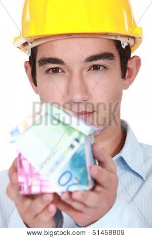 Builder with a house made of money