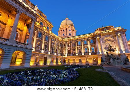 The Buda Castle In Budapest And A Flower Bed Before