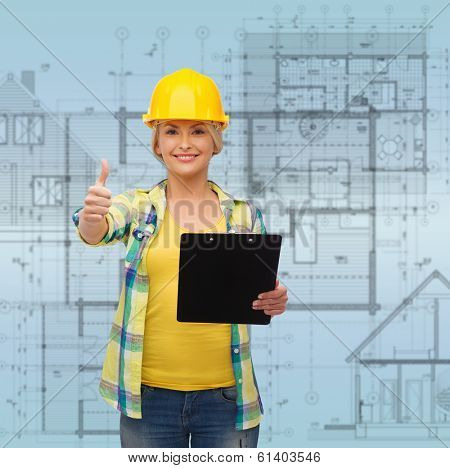 repair, construction and maintenance concept - smiling woman in helmet with clipboard showing thumbs up