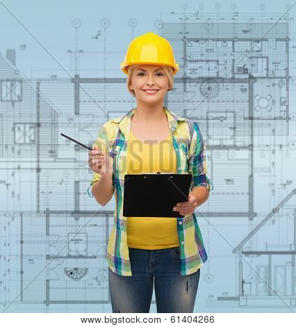 repair, construction and maintenance concept - smiling woman in helmet with clipboard