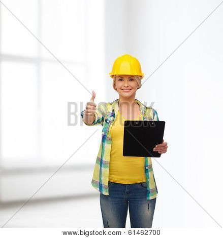 repair, construction and maintenance concept - smiling woman in helmet with clipboard showing thumbs up