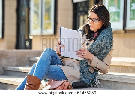 Young woman student reading outdoor