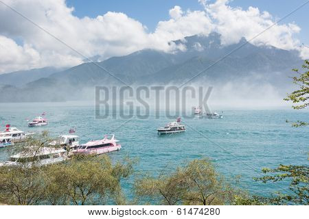 NANTOU, TAIWAN - FEBRUARY 20 : Many tourist people take a trip by boats at the lake of famous attraction, Sun Moon Lake at Taiwan on february 20, 2013 in Nantou county, Taiwan, Asia. 