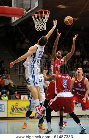KAPOSVAR, HUNGARY - MARCH 8: Marton Horvath (white 21) in action at a Hungarian Championship basketball game with Kaposvar (white) vs. Paks (red) on March 8, 2014 in Kaposvar, Hungary.