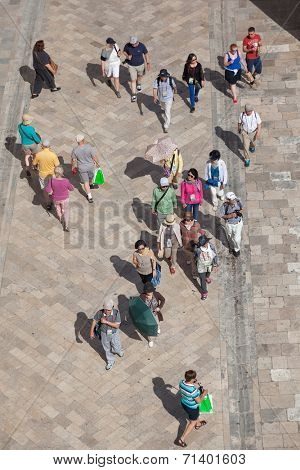 DUBROVNIK, CROATIA - MAY 26, 2014: Aerial view from old city walls of tourists walk on Stradun, 300 meters long main pedestrian street in Dubrovnik.