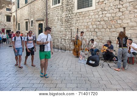 DUBROVNIK, CROATIA - MAY 26, 2014: Street band performing on Stradun.  Stradun is 300 meters long main pedestrian street in Dubrovnik.