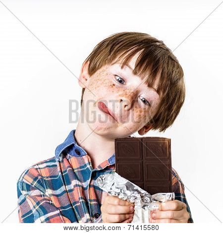 Happy Red-haired Boy With Chocolate Bar