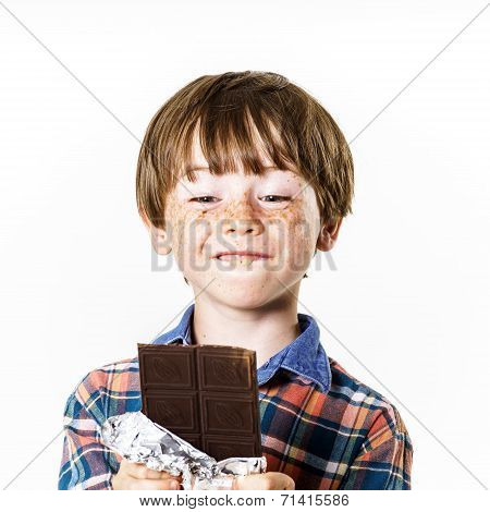 Happy Red-haired Boy With Chocolate Bar
