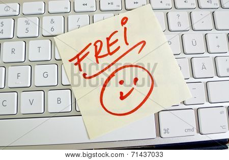 a sticky note is on the keyboard of a computer as a reminder: free
