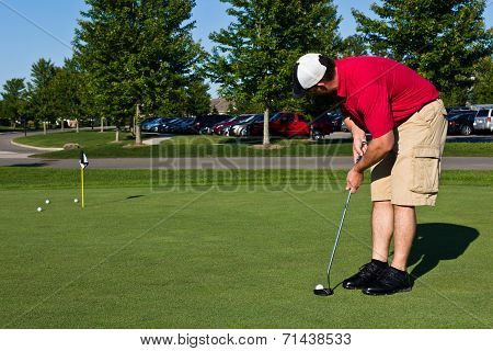 Golfer Practicing Putting Golf Balls