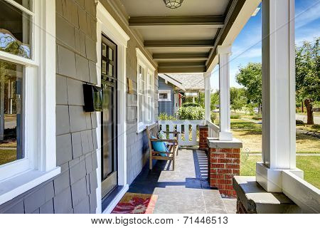 Large Entance Porch With Brick Trim And White Railings