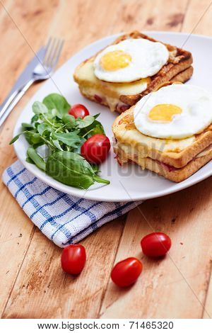 Croque madame on wooden table