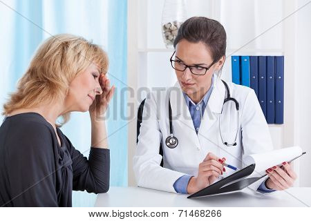 Woman With Migraine In Doctor's Office