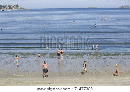 BAIONA, GALICIA, SPAIN - AUGUST 30: people walking at the beach, on August 30, 2014 in Baiona, Galicia, Spain.