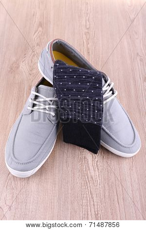 Top-siders and socks on wooden background