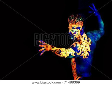 Body art glowing in ultraviolet light