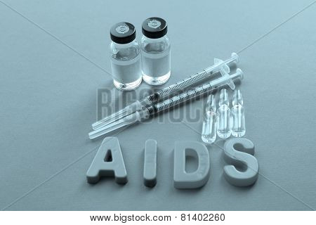 Medicines with word Aids on pink background