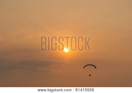 silhouette of paramotor with sunset sky