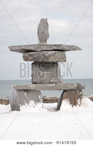 Stone Inuksuk In Snowy Landscape