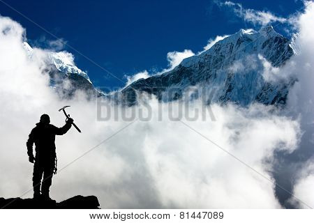Silhouette Of Man With Ice Axe In Hand